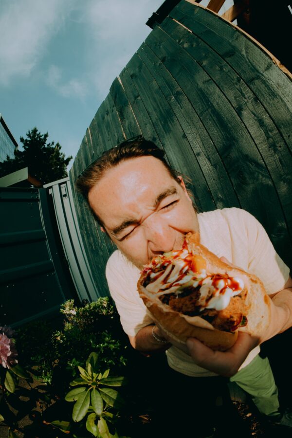 person biting into a hotdog